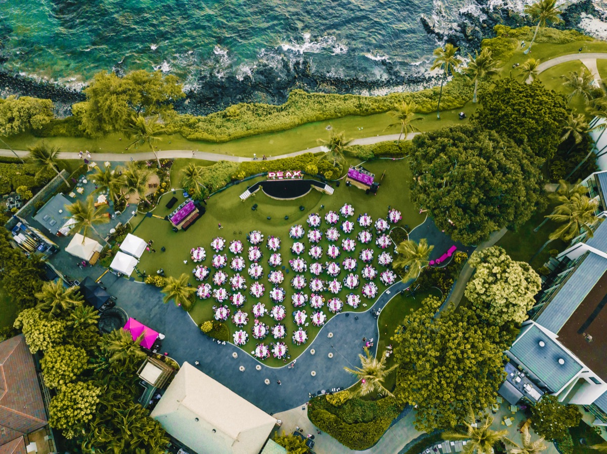 Aerial view of an oceanfront lawn set for an outdoor event.