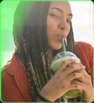 An employee sipping an iced drink